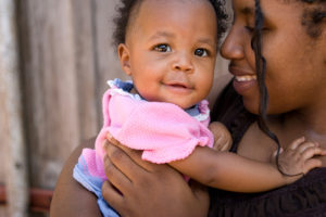 Baby with bright eyes with mom
